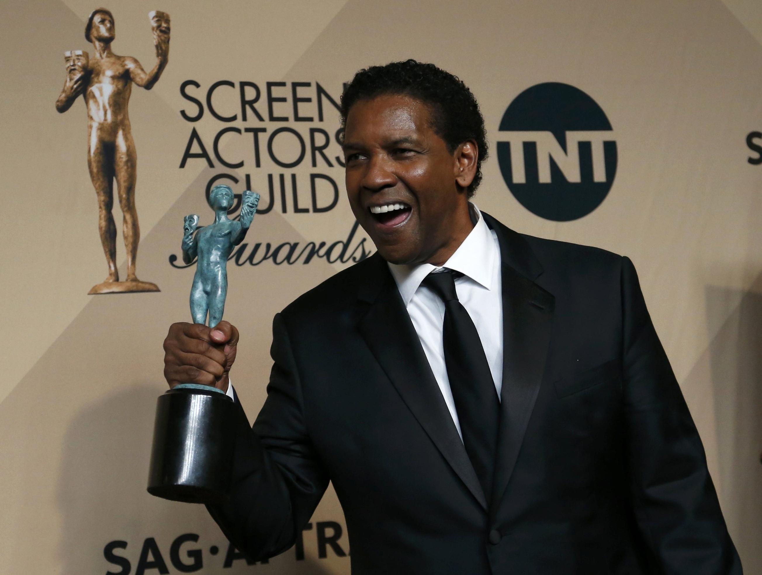 Denzel Washington poses with the award he won for Outstanding Performance by a Male Actor in a Leading Role for "Fences" backstage at the 23rd Screen Actors Guild Awards in Los Angeles