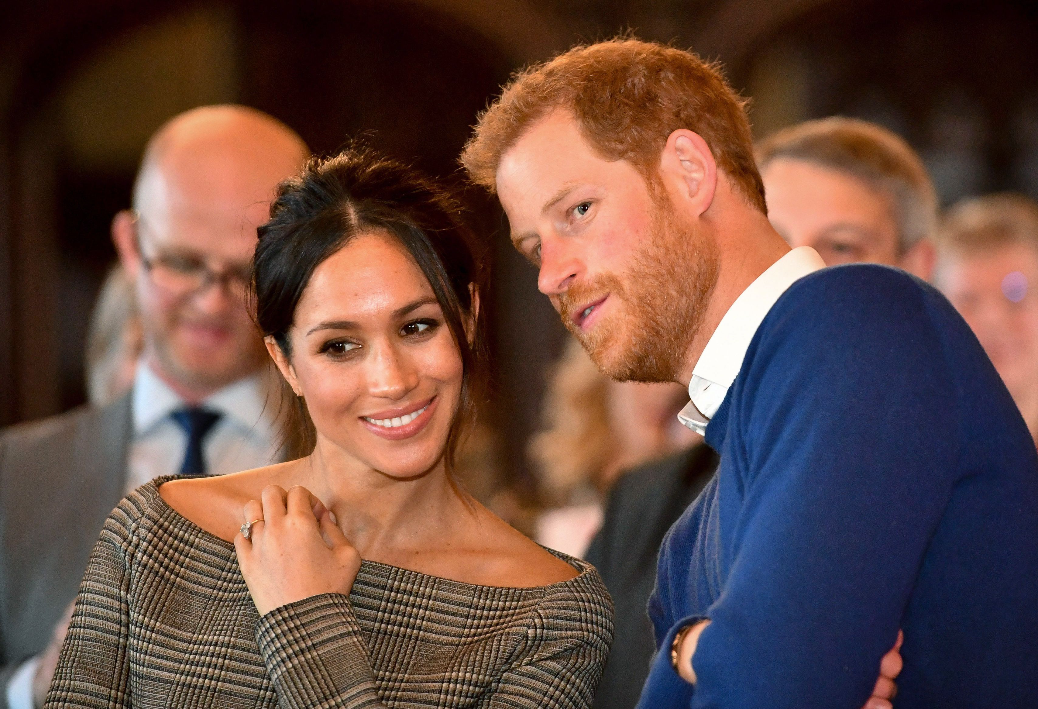 prince-harry-whispers-to-meghan-markle-as-they-watch-a-news-photo-906665892-1539601431